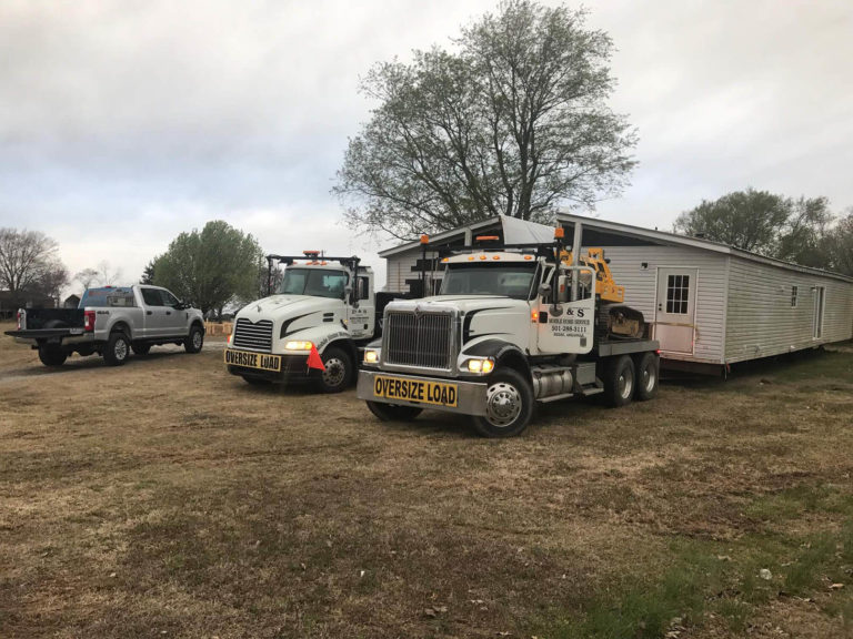 Our trucks lined up with a single-wide ready to move Our trucks lined up with a single-wide ready to move