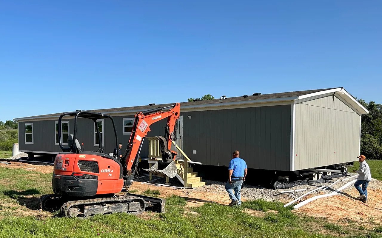 Site work next to a newly delivered home