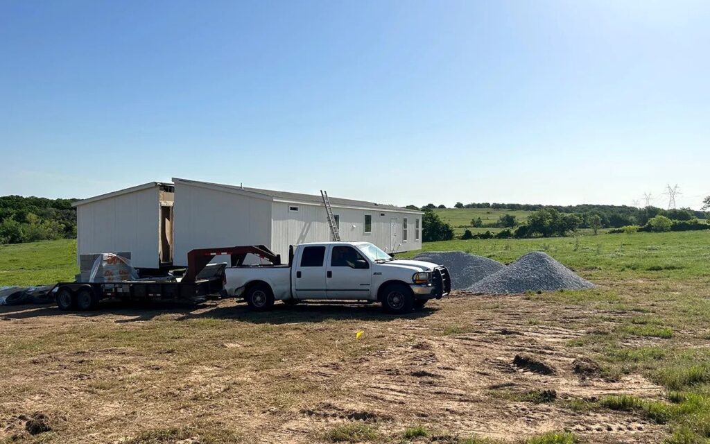 Double-wide mobile home delivered to its new site